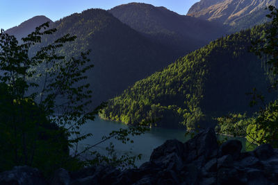 Scenic view of lake and mountains against sky