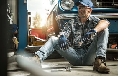 Low section of man sitting in car