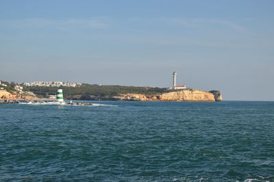 View of built structure by sea