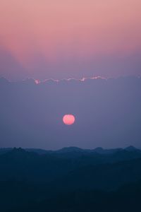 Scenic view of silhouette mountains against sky during sunset