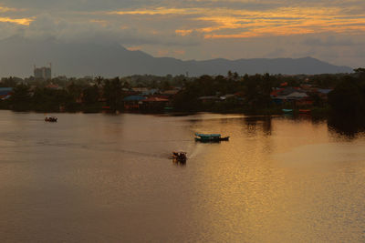 Scenic view of river against sky during sunset