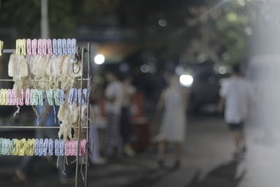 Illuminated lanterns hanging on street in city at night