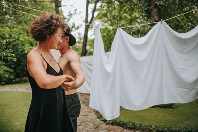 Midsection of woman standing by tree