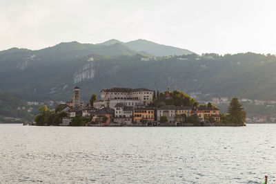 The island san giulio in lake d'orta seen from the waterfront of the little town in northern italy