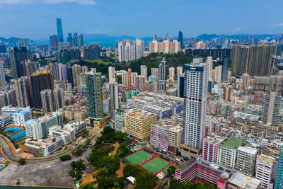 High angle view of modern buildings in city against sky