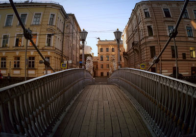 Street amidst buildings against sky in city