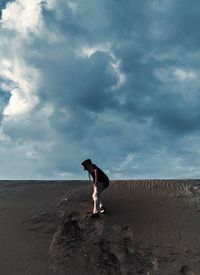 Side view of man standing on desert