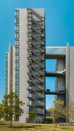 Low angle view of modern building against clear blue sky