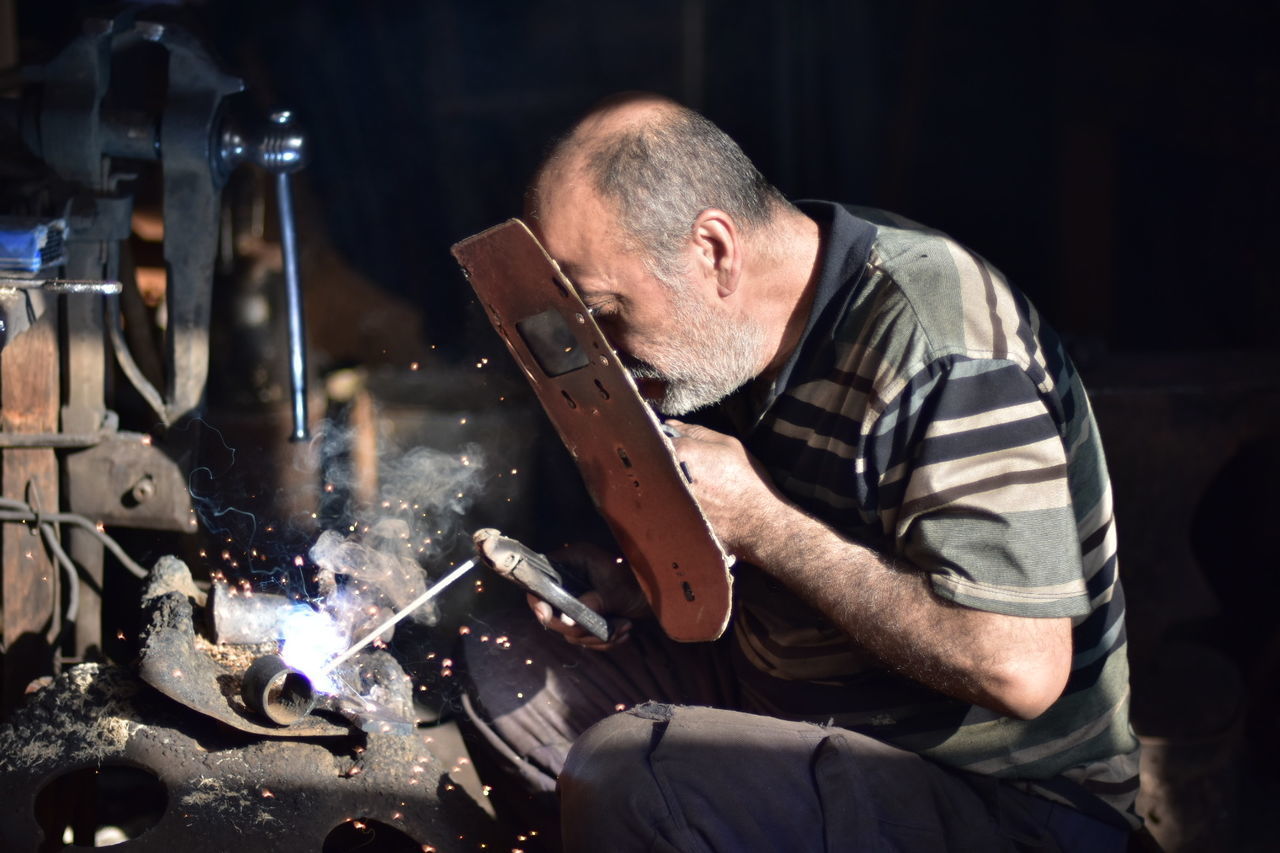 MAN WORKING ON SHELF IN KITCHEN