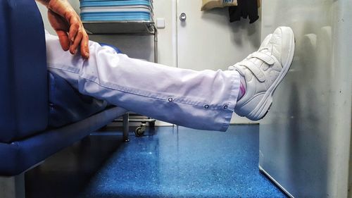 Low section of man wearing shoes
