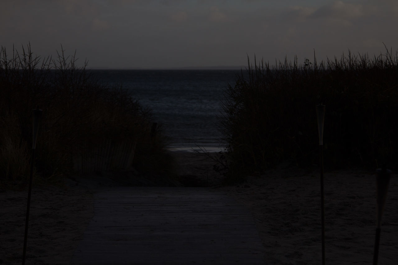 SCENIC VIEW OF BEACH AGAINST SKY AT DUSK