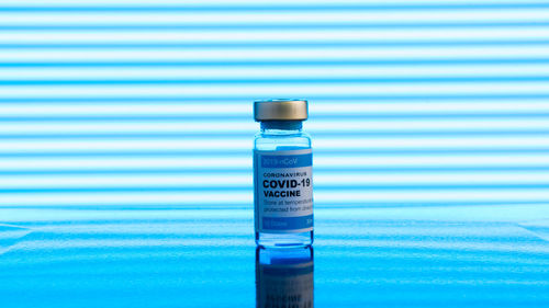 Close-up of bottle with blue water