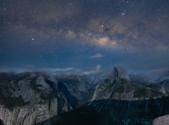 Scenic view of mountains against sky at night