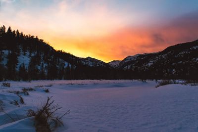 Scenic view of snow mountains against sky during sunset