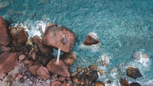 High angle view of rocks at sea shore