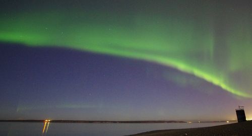 Scenic view of rainbow over sea at night