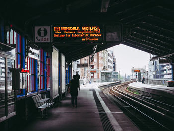 Rear view of people on railroad station platform
