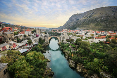 High angle view of townscape and bay against sky