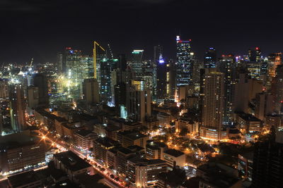 High angle view of illuminated modern buildings in city at night