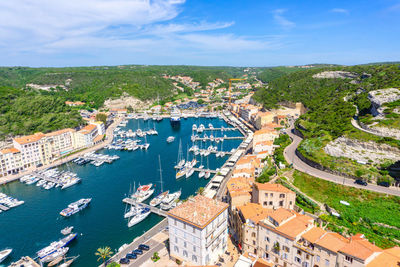 High angle view of buildings and sea against sky