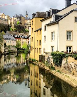 Arch bridge over river amidst buildings in town