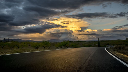 Empty road along countryside landscape