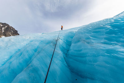 Distance shot of a man walking on snowed landscape