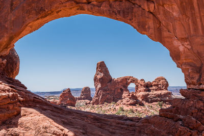 Rock formations against clear blue sky