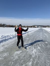 Low angle view of man skating on the lake