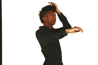 Young man looking away against white background