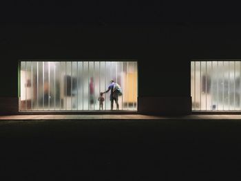 Rear view of man walking in subway station