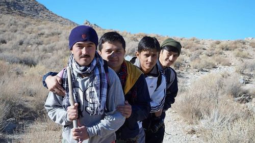 Portrait of friends standing on land