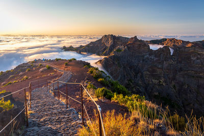 Scenic view of sea and mountains against sky