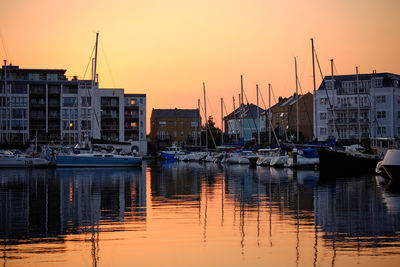 Sovereign harbour eastbourne at sunset with reflections of boats and buildings