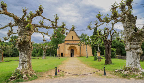 Trees and historic building against sky