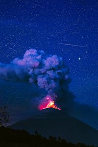 Scenic view of mountain against sky at night