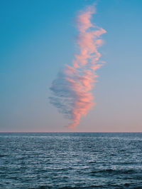 Scenic view of single cloud and sea against sky during sunset