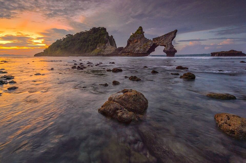 ROCKS ON BEACH AGAINST SKY