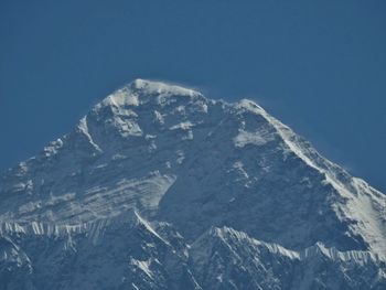 Scenic view of snowcapped mountains against clear blue sky