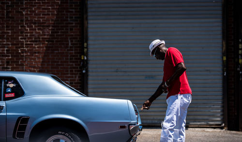 Side view of a woman holding car