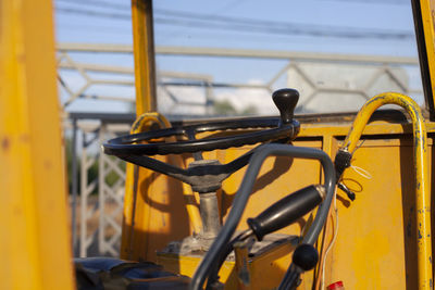 The steering wheel is at the bulldozer. bulldozer in the parking lot. old industrial equipment.