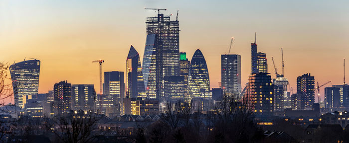 Buildings in city during sunset