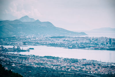 Scenic view of sea and mountains against sky