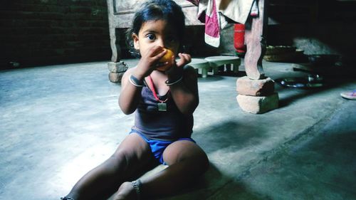 Portrait of cute girl sitting outdoors