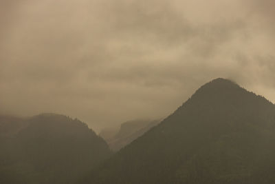 Scenic view of silhouette mountains against sky