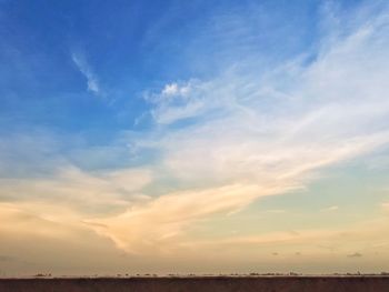 Scenic view of field against sky at sunset