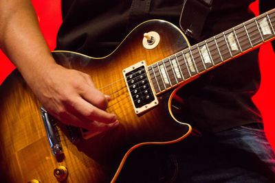 Close-up of man playing guitar