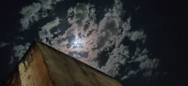 Low angle view of storm clouds at sunset