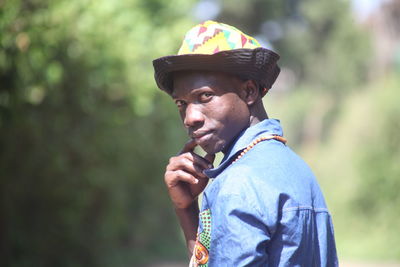 Portrait of young man looking away outdoors