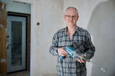 Portrait of senior man working at home